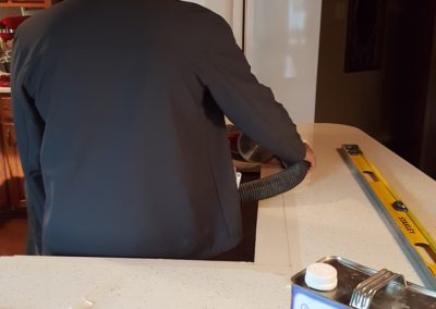 Person cleaning kitchen with vacuum