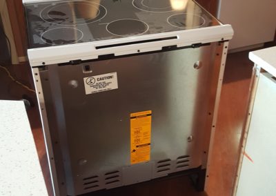 Stove partially installed in kitchen