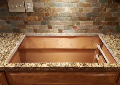 Empty kitchen countertop with stone backsplash