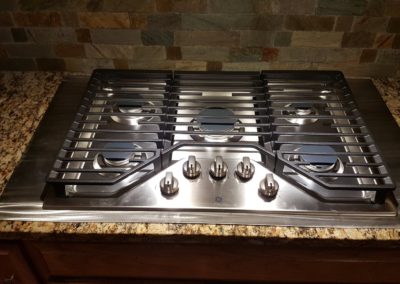Stainless steel gas cooktop on countertop